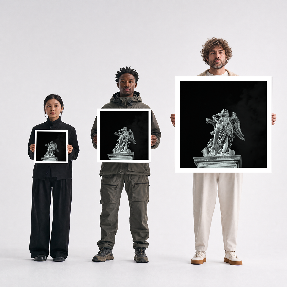 Scale comparison photo showing the 12x12, 20x20, and 40x40 print sizes of 'Mike' by Sunday Morning, held by three models for size reference.